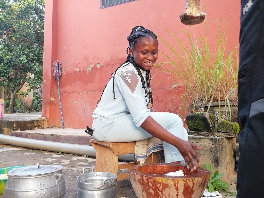 Comfort of team moon&star shows how to make fufu during traditional african cooking workshop